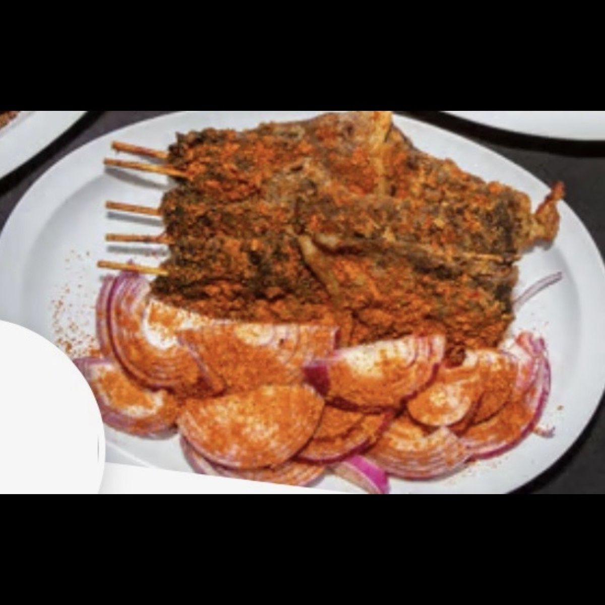 Suya sticks with sliced onions